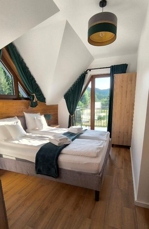 Posteľ alebo postele v izbe v ubytovaní Korona Pienin Domki & Apartamenty