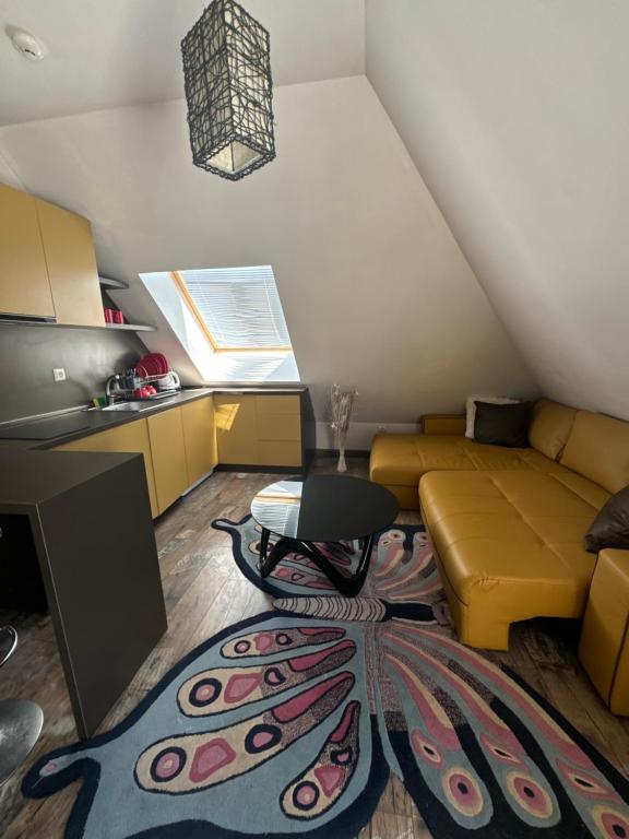 a living room with a couch and a table and a rug at Residensia Bahami in Sunny Beach
