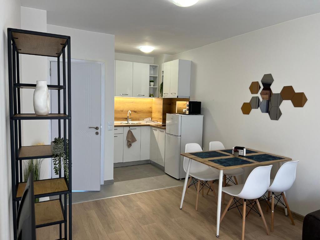 a kitchen and dining room with a table and chairs at Apartment D25 Pomorie in Pomorie