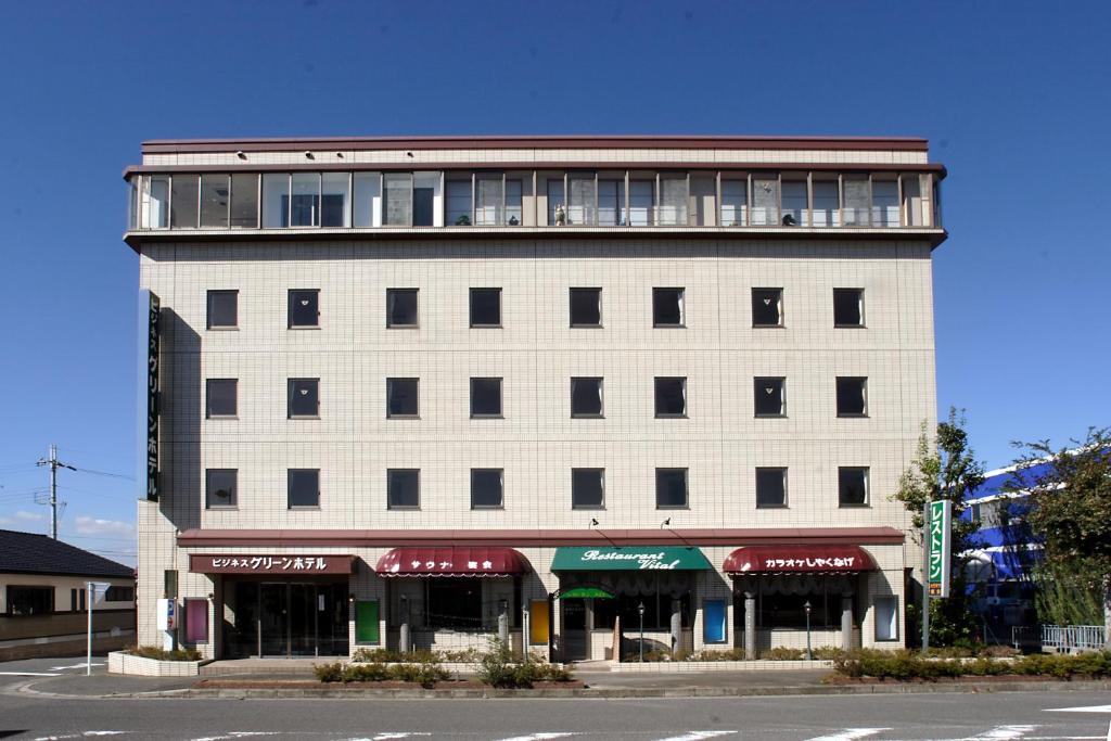 a large white building with a lot of windows at Business Green Hotel Hino in Hino