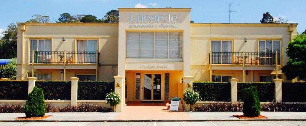 a building with a sign that reads lifestyle at Lifestyle Apartments at Ferntree in Fern Tree Gully