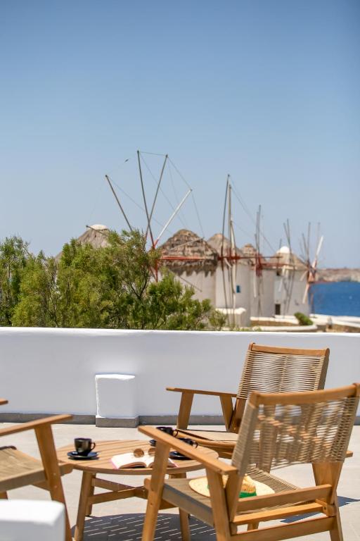 a group of chairs and a table on a balcony at Mykonos Windmills View in Megali Ammos
