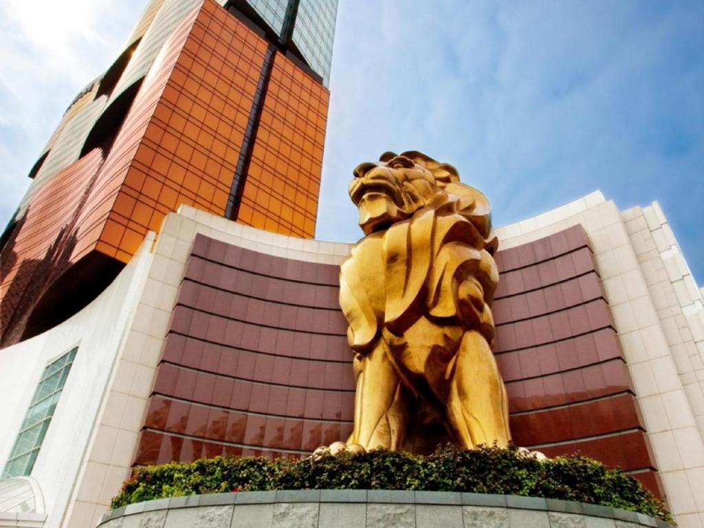 a golden lion statue in front of a building at MGM Macau in Macau