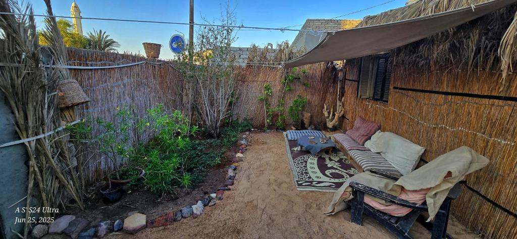 an outdoor patio with a couch and a fence at Dahab house home in Dahab
