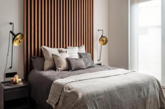 a bedroom with a large bed with two lamps on it at Hotel Boutique Premium Exclusivo in Paine