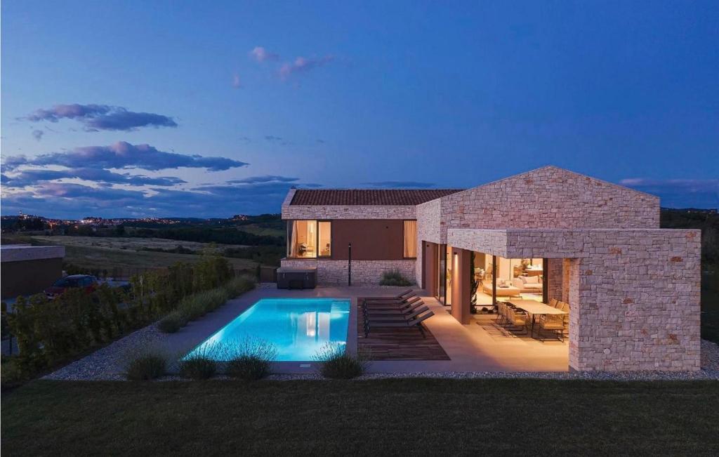 a house with a swimming pool in the backyard at Luxury Villa Vigneto heated pool jacuzzi in Brtonigla