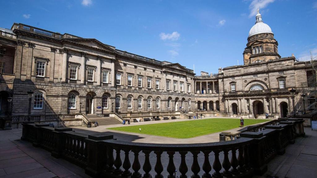 a large building with a clock tower on top of it at Edinburgh Centre - George Square Residence in Edinburgh