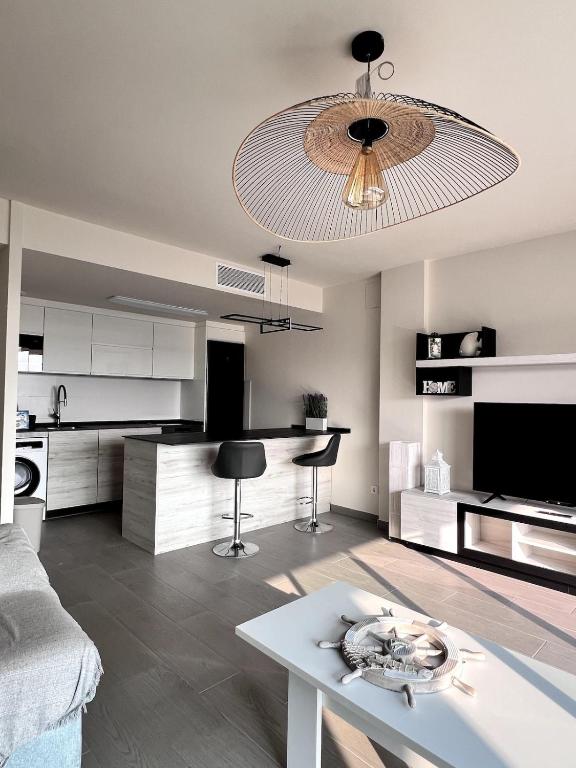 a living room with a couch and a table at Top apartment! in Benajarafe