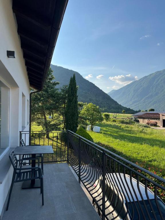 a balcony with a table and chairs and mountains at Razor Vista Apartment in Tolmin