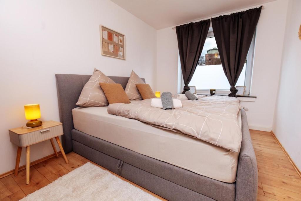 a large bed in a room with a window at classic & cream - Netflix - WIFI - City - 4 Person in Essen