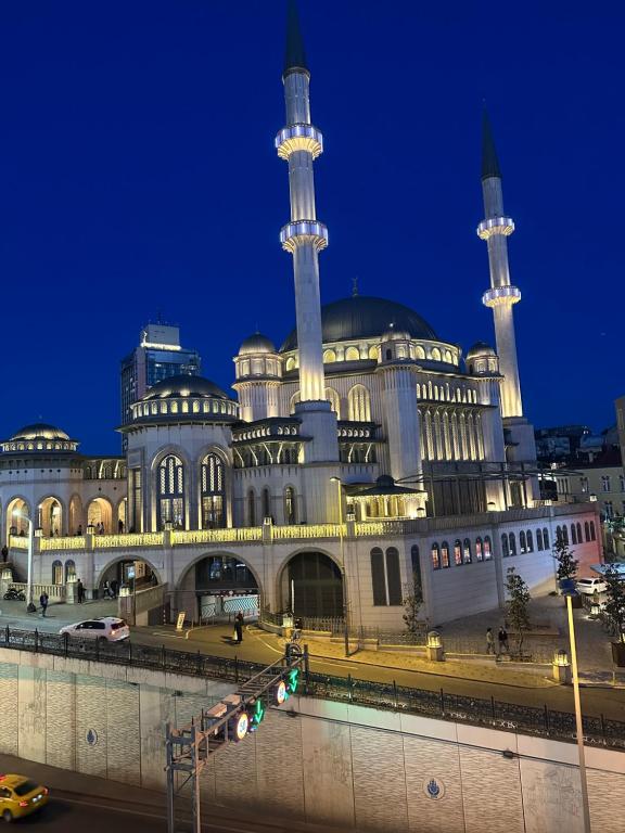 a large building with two mosques at night at The Square 30 in Istanbul