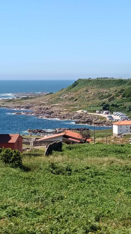 a group of buildings on a hill next to the ocean at Villa Ruperta in A Guarda