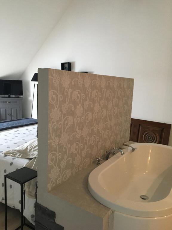 Postel nebo postele na pokoji v ubytování B&B Haras de la Cour Fleury