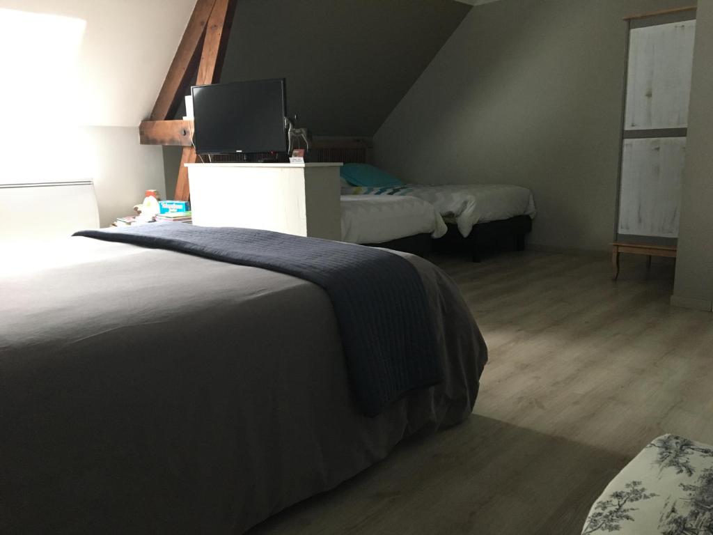 Postel nebo postele na pokoji v ubytování B&B Haras de la Cour Fleury