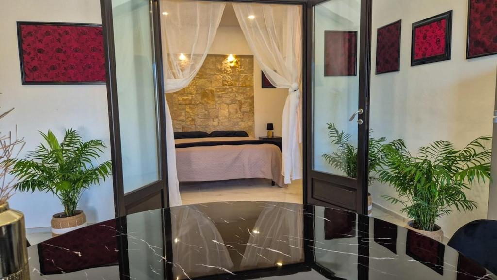 a room with a mirror and a bedroom with a bed at Borgo Antico - Monili di Sardegna in Lotzorai