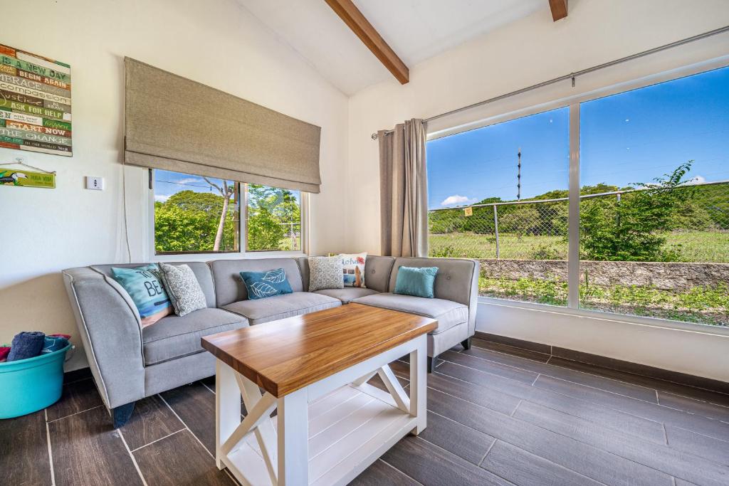 a living room with a couch and a table at Villarreal House in Tamarindo