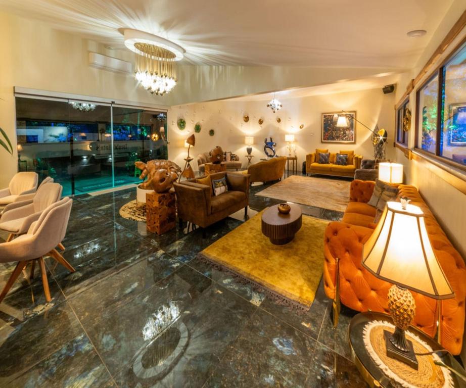 a living room filled with furniture and a pool at Hotel & Spa Poco a Poco - Costa Rica in Monteverde Costa Rica