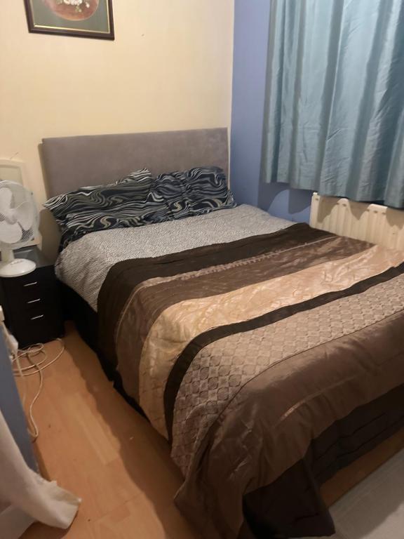 a bed sitting in a bedroom with a window at Home Sweet Home in Moffat