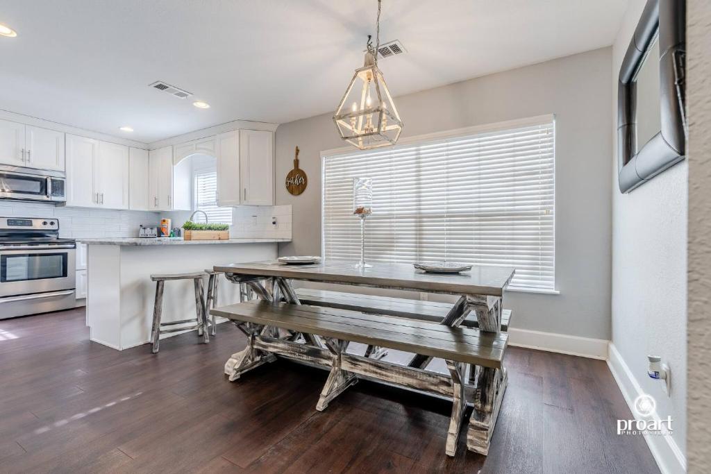a kitchen with a table and a bench in it at Vitamin Sea 0.6 miles to beach, monthly disc in Destin