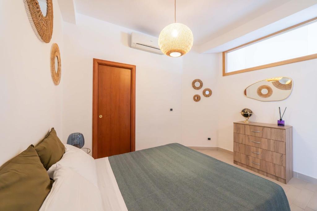 a bedroom with a large bed and a window at A Me Casa - Taormina in Taormina