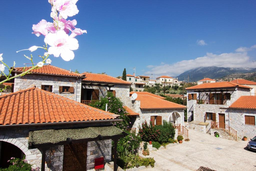 a group of buildings with red roofs and flowers at Stephanou Inn in Agios Nikolaos