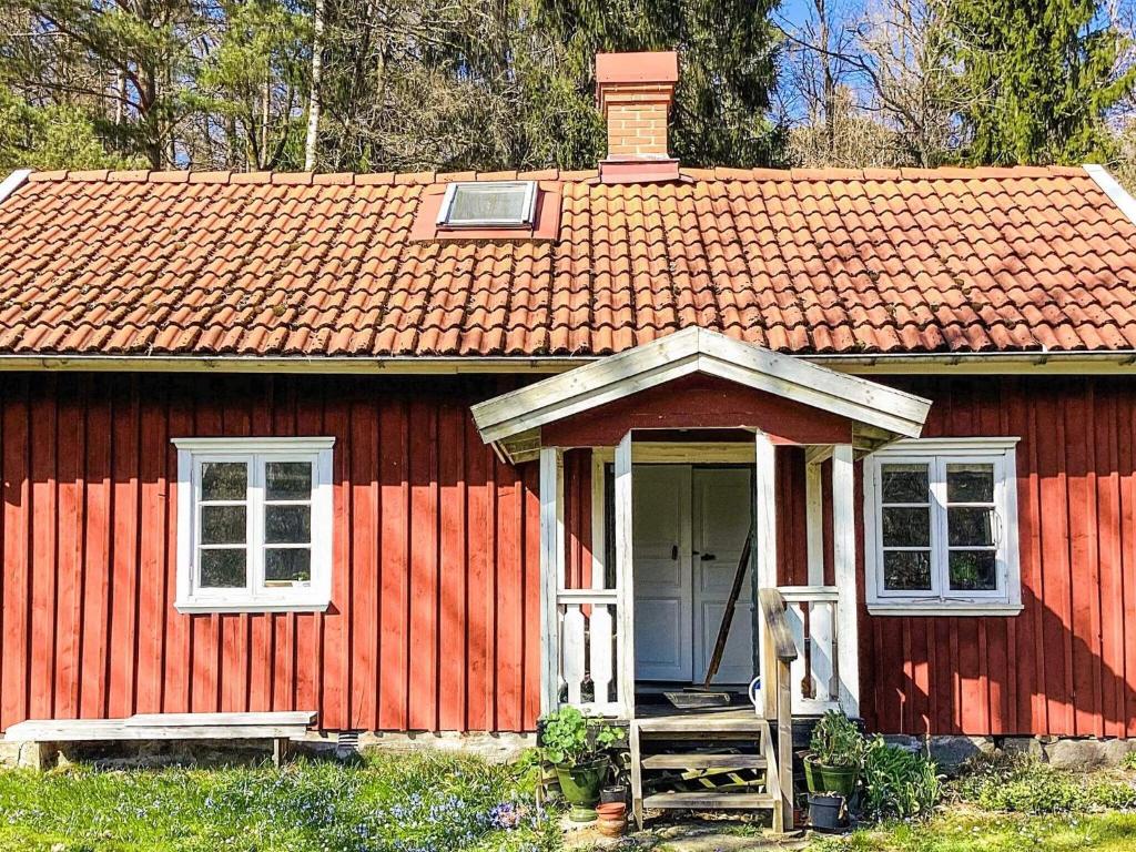 a red tiny house with a red roof at 4 star holiday home in ISTORP in Istorp