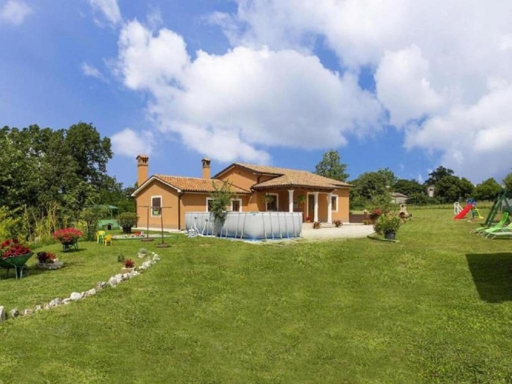 a house with a large yard in front of it at Villa in minj with swimming pool in Žminj