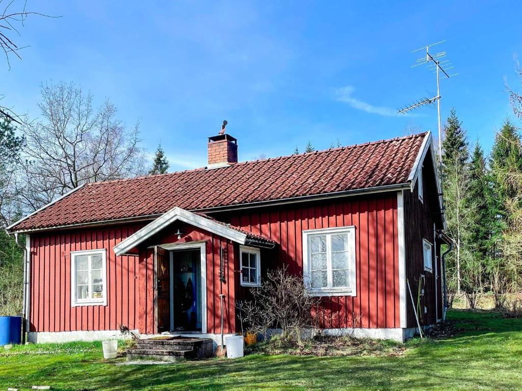 a red house with a red roof at 6 person holiday home in mellerud in Mellerud