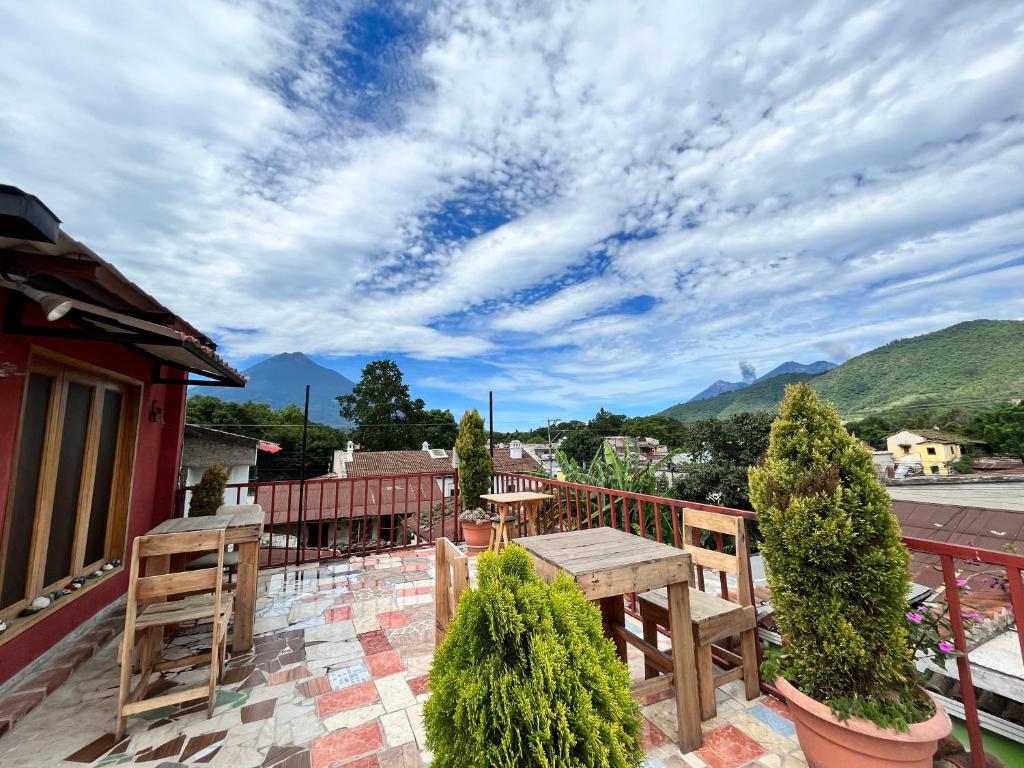 a patio with a table and chairs on a balcony at Jireh guesthouse in Antigua Guatemala