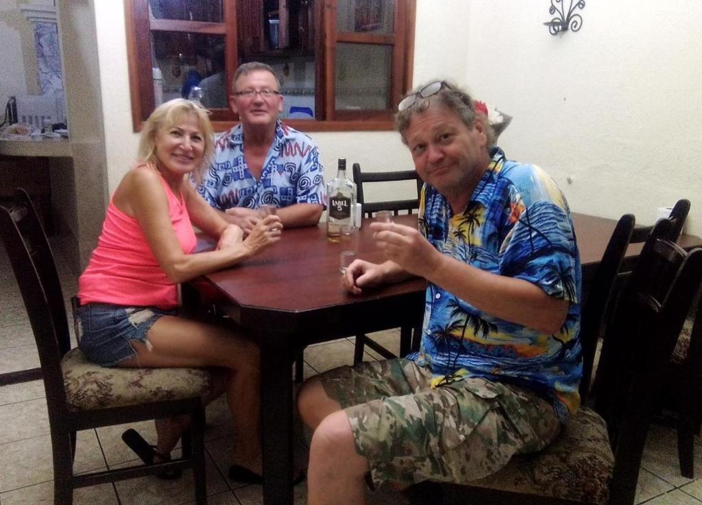 a group of three people sitting at a table at Jireh guesthouse in Antigua Guatemala