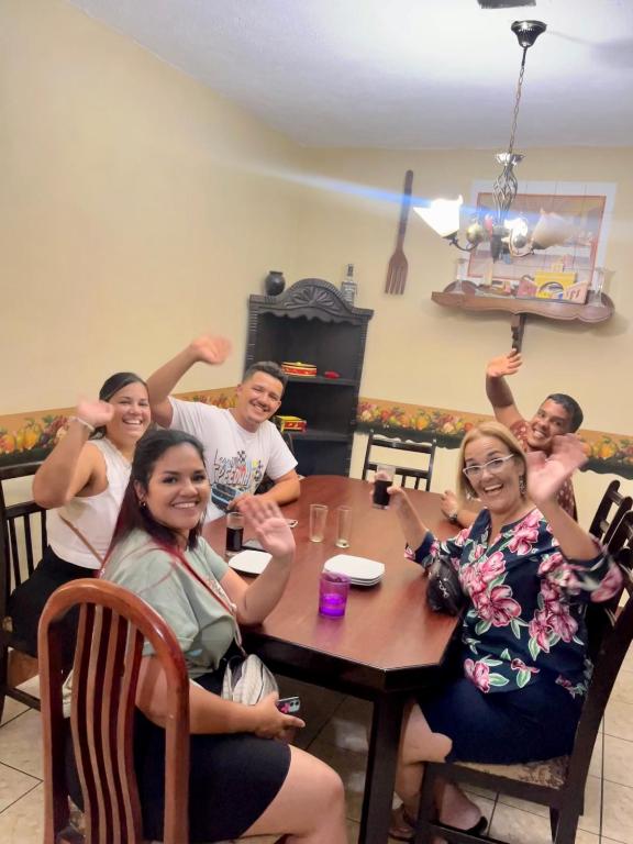 a group of people sitting around a table at Jireh guesthouse in Antigua Guatemala