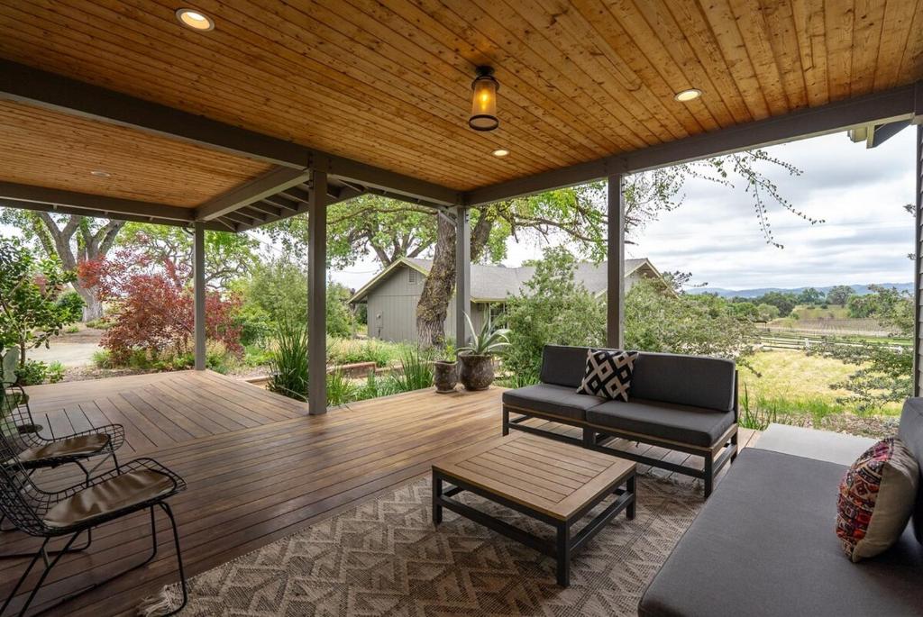 a screened in porch with a couch and a table at Castoro Cellars Hive and Hivette Wine Stay, Groups in Templeton