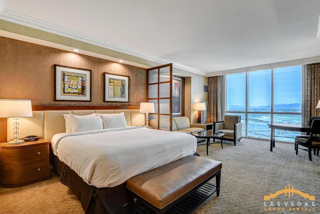a hotel room with a large bed and a desk at MGM Signature-22-604 Jacuzzi Studio in Las Vegas