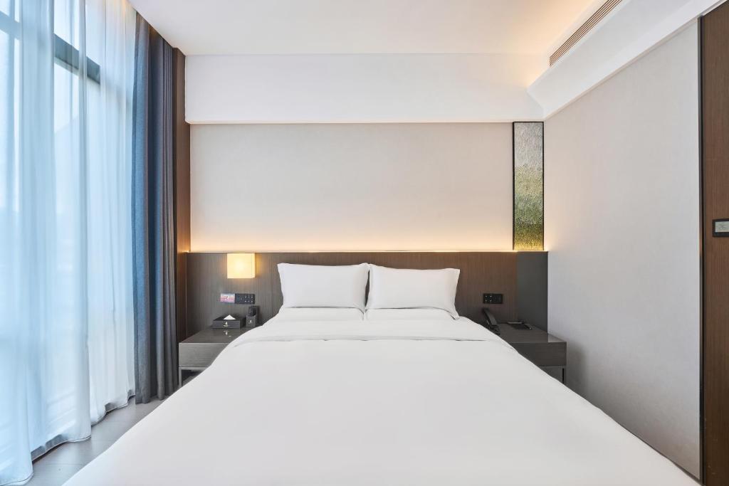Postel nebo postele na pokoji v ubytování Beijing Suiyu Hotel