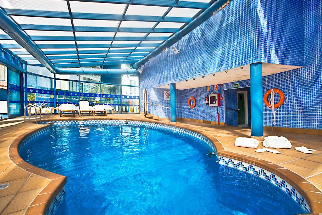 a large swimming pool in a large building at Hotel Madeira Centro in Benidorm