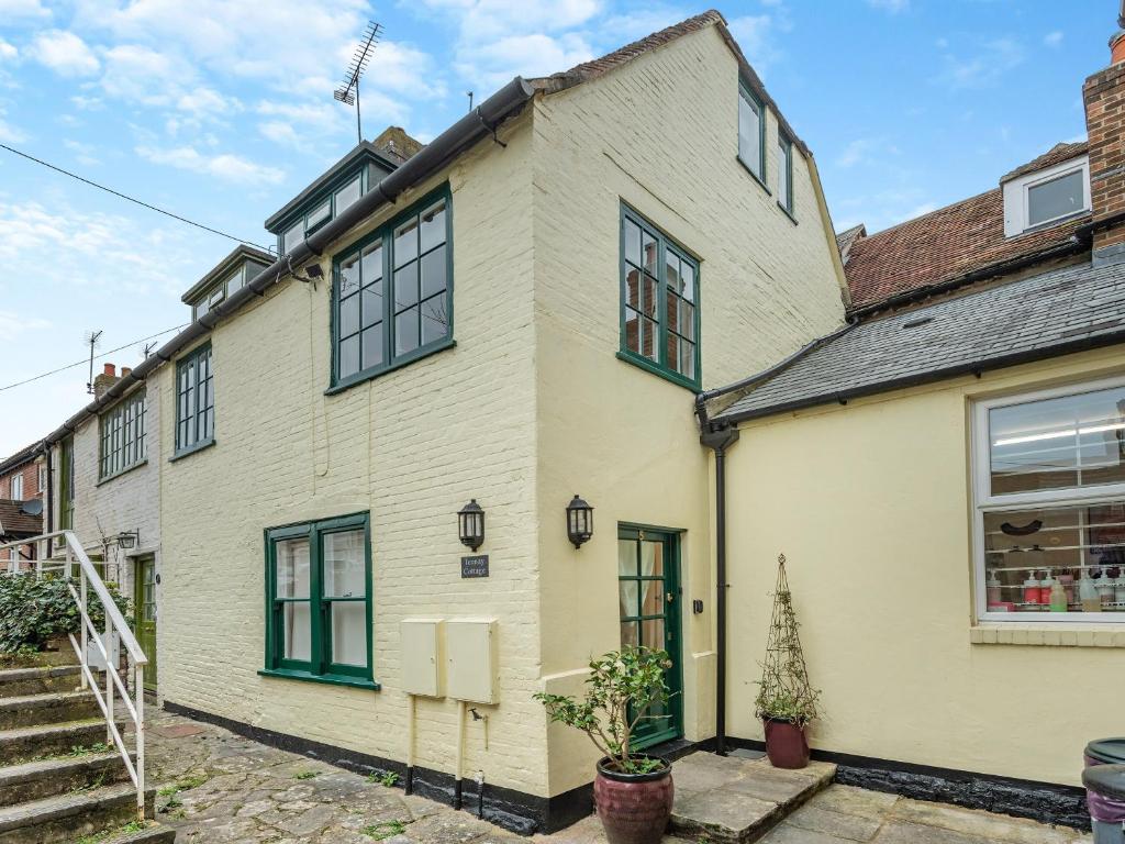 a large white house with green windows at Tennay Cottage in Wareham