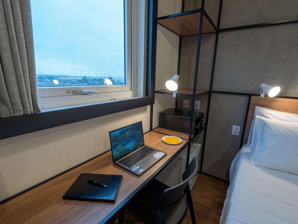 Postel nebo postele na pokoji v ubytování ibis Guarapuava