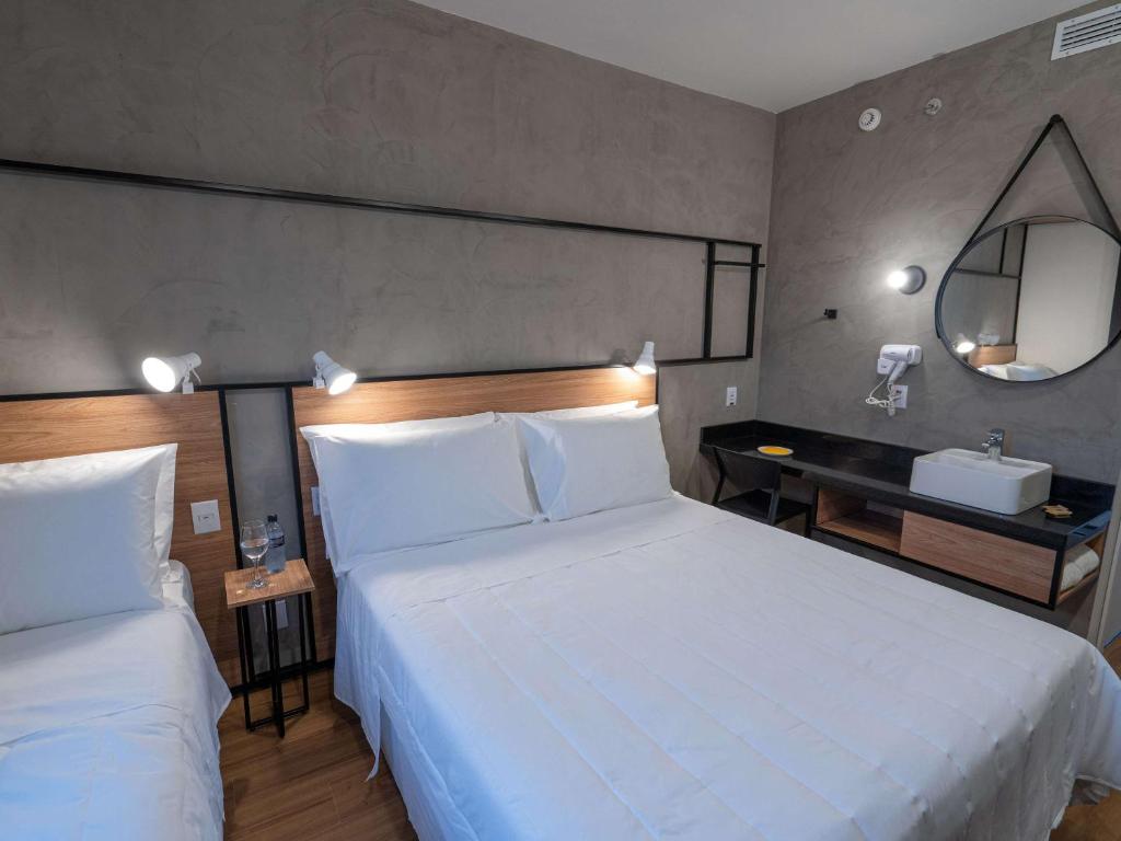 Postel nebo postele na pokoji v ubytování ibis Guarapuava