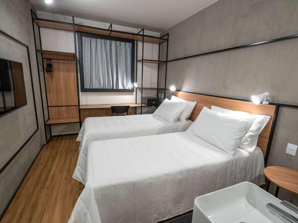 Postel nebo postele na pokoji v ubytování ibis Guarapuava
