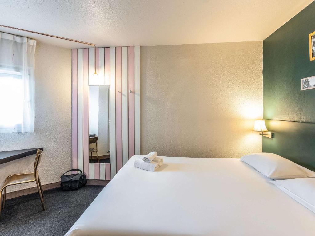 Postel nebo postele na pokoji v ubytování Greet Hotel Limoges Nord