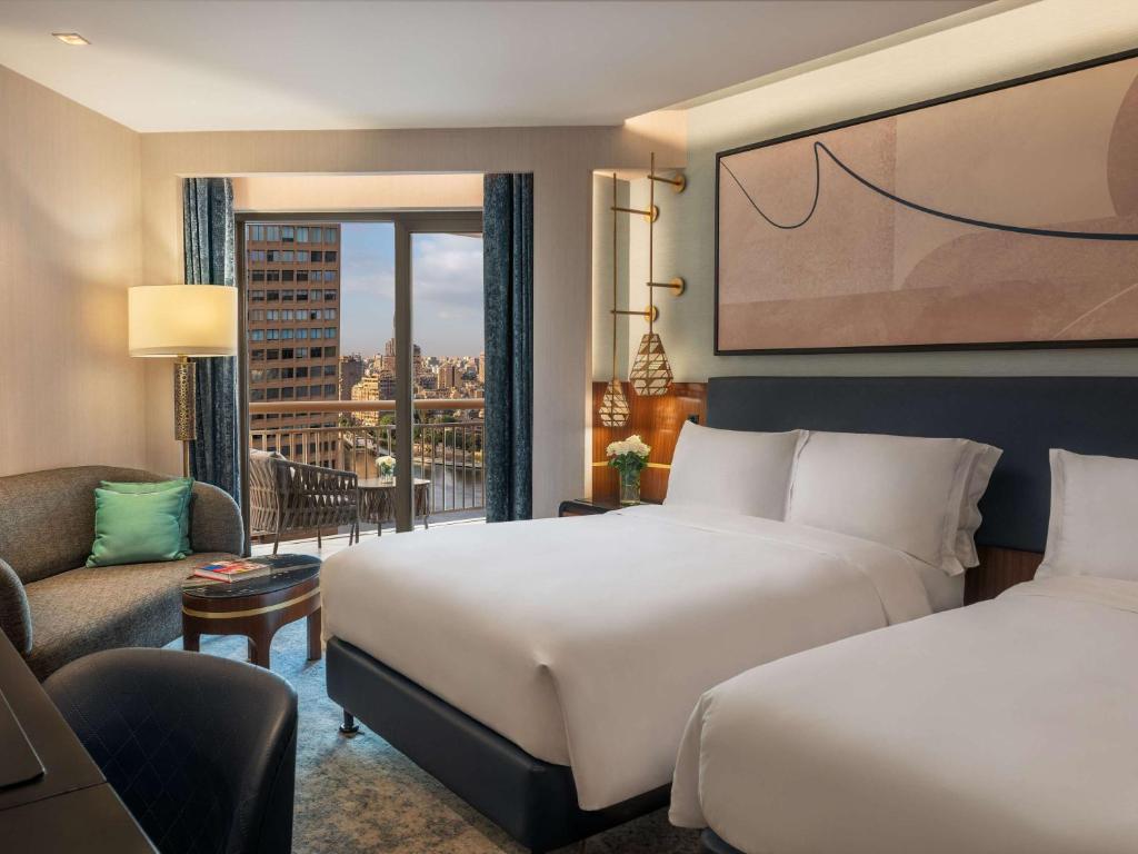 Postel nebo postele na pokoji v ubytování Sofitel Cairo Downtown Nile