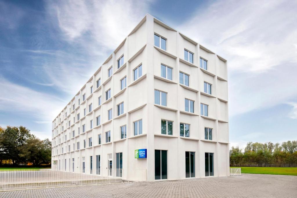 a white building with windows on the side of it at Holiday Inn Express &amp; Suites Ghent by IHG in Ghent