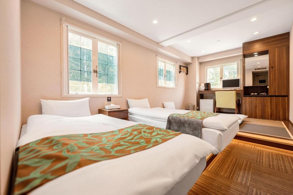 Postel nebo postele na pokoji v ubytování Hakuba Sun Valley Hotel Annex - Vacation STAY 90351v