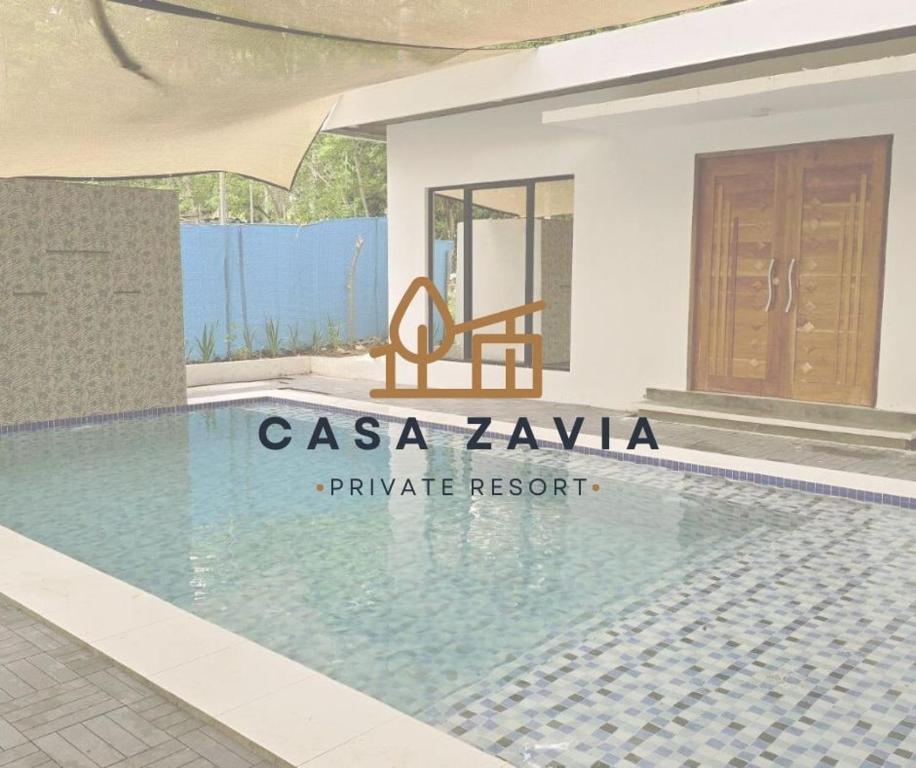 a swimming pool in front of a villa at Casa Zavia in Sampong