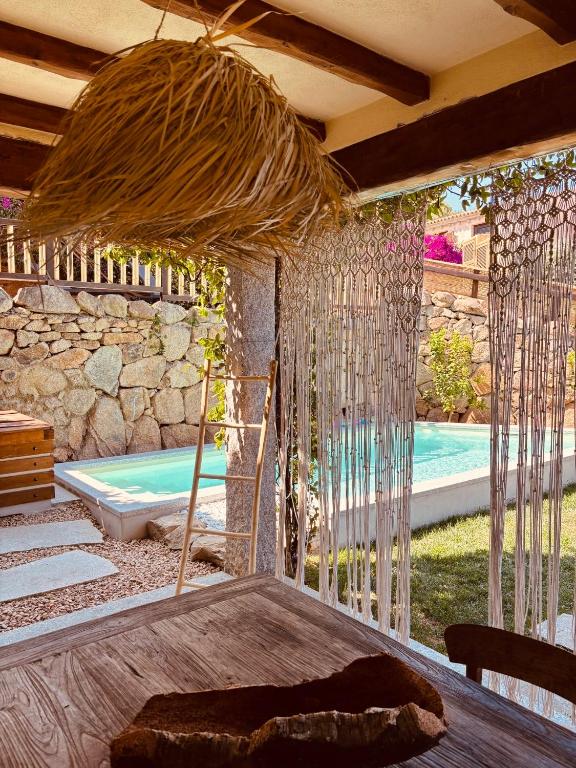 a room with a bed and a swimming pool at Isola Sarda Appart NICE in Murta Maria