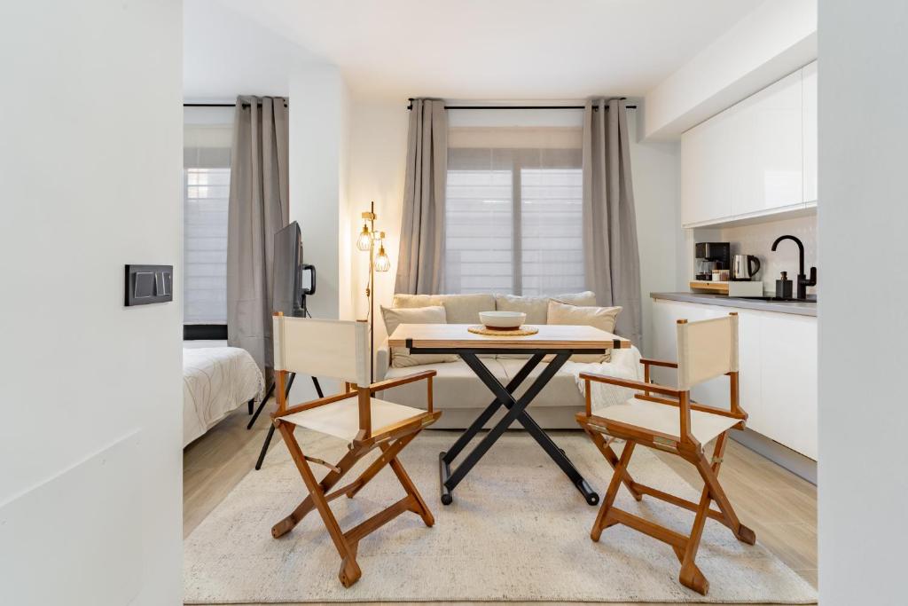 a kitchen and living room with a table and chairs at Arena One Studio in Fuengirola