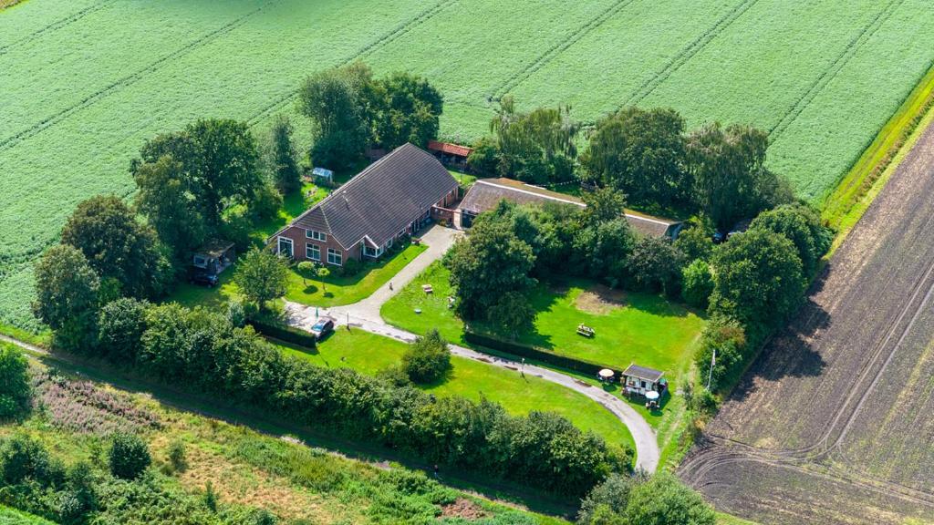 an aerial view of a house in a field at Buitengoed Het Achterdiep in Ter Apel