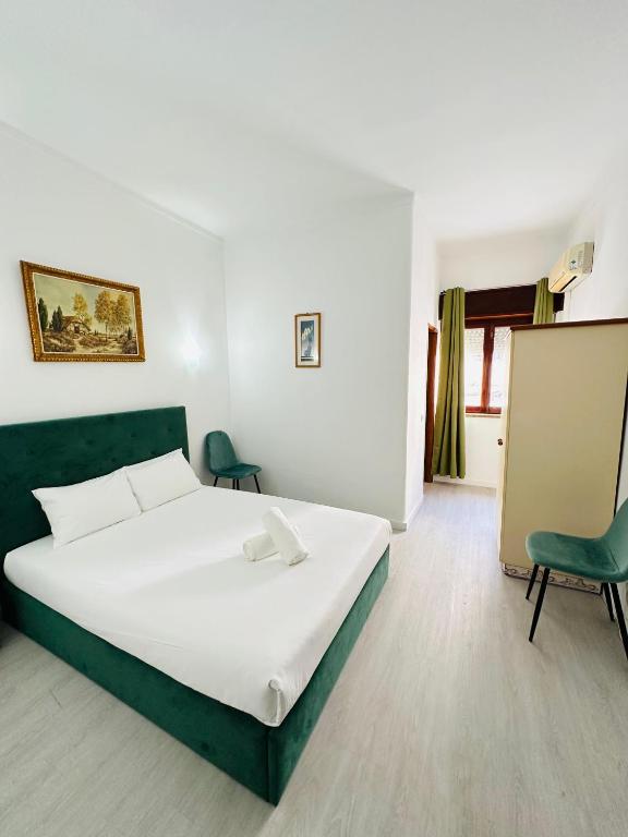 a bedroom with a large white bed and two chairs at Residencial Pimenta ,Portimao,Algarve in Portimão