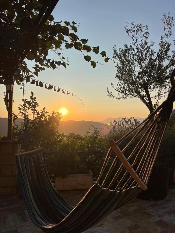 a hammock with the sunset in the background at Apartmani Gazivode in Budva