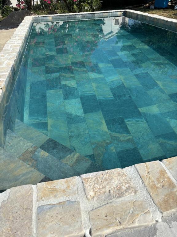 a swimming pool with blue and green at Mermaid Cove in Sukošan